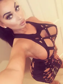 brunette bimbo in a strappy black dress