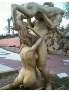 threesome statue with two woman and one man licking together