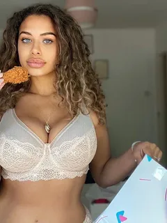 chanelle mauricette in her bra and panties with a piece of chicken.