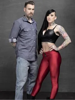 genevieve zitricki is alt facsimile imitation of flawless miniature sex model with goth hair while standing next to a soyboy - sgb lett