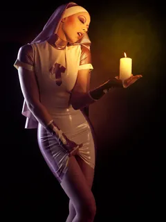 nun holding a candle