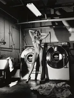 naked woman standing in a laundry room