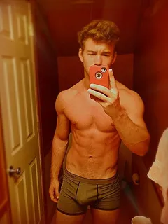 hot redhead guy taking selfie in bathroom mirror with dick sticking up