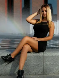 curvy and leggy blonde outdoors in tight mini dress and ankle boots