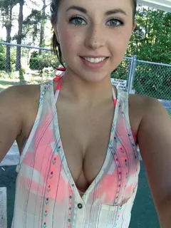 cute chick has a smile on his face and a big cleavage.