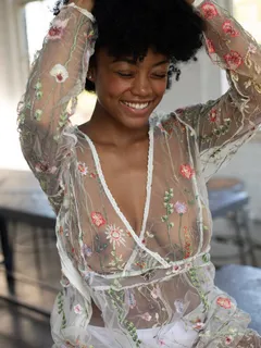 cute black woman smiling showing her tits in see through lingerie