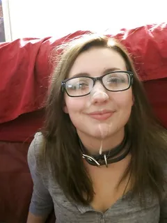 cute amateur brunette in a collar with glasses and cum on her face