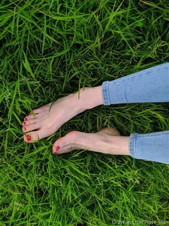 pale skinny feet in grass