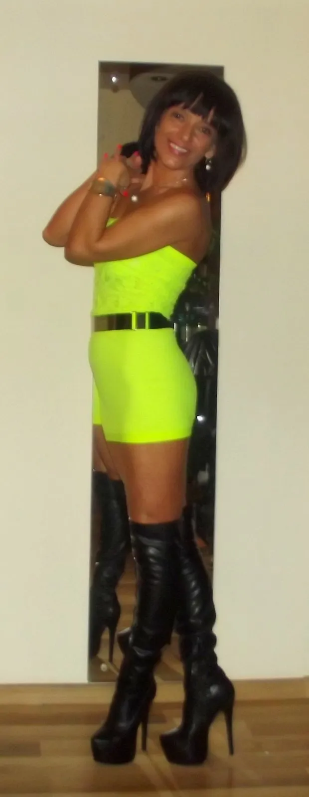 sexy tanned milf in tight micro dress and leather heeled boots