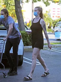 ireland baldwin braless boobs in a black tank top showing off her big tits pokies out shopping with her boyfriend corey harper seen by papar