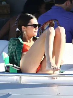 kendall jenner in a sexy thong bikini on a yacht with friends tanning showing her perfect model body seen by paparazzi.