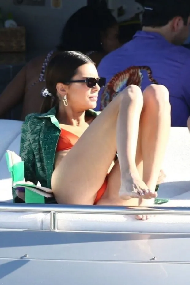 kendall jenner in a sexy thong bikini on a yacht with friends tanning showing her perfect model body seen by paparazzi.