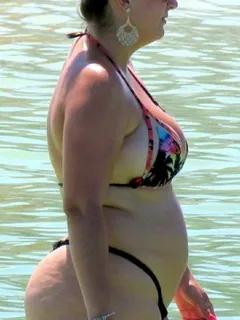 that tiny bikini fails to hide her curves...