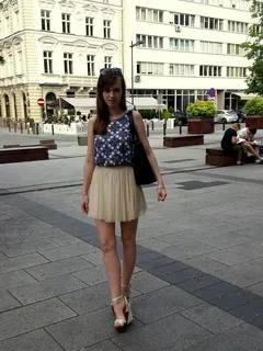 cute young eighteen wearing see thru mini skirt and high wedges, outdoors