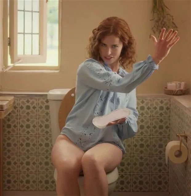 redhead woman (lisa o'connor) sitting on the toilet without pants for a commercial. slut, what you don't do to make money - tena discreet