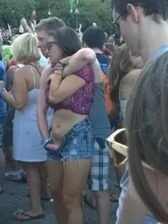 as her legs tremble he holds her up while she cums in front of everyone at the concert.