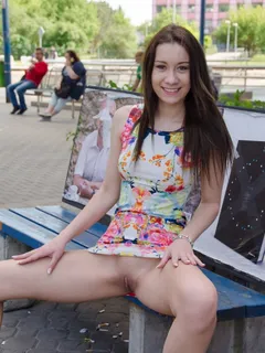 cute woman raises skirt to show shaved pussy in public