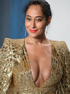 tracee ellis ross braless boobs showing nice cleavage with her big tits in a low cut sexy gold dress at the vanity fair oscar party.