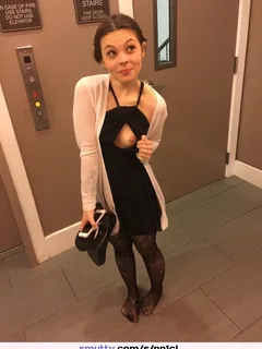 petite, well dressed cutie showing you her piercing.