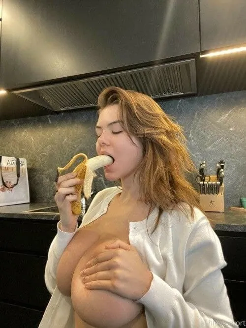 eating banana holding g boobs