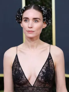 rooney mara braless boobs in a see through dress showing off her tits and cleavage photographed arriving to the golden globe awards.