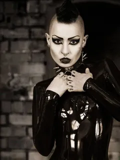 toxic devil is a sinister yung goth model in black latex with her weird hair emo mo hawk - fota lett gothh ppale collar