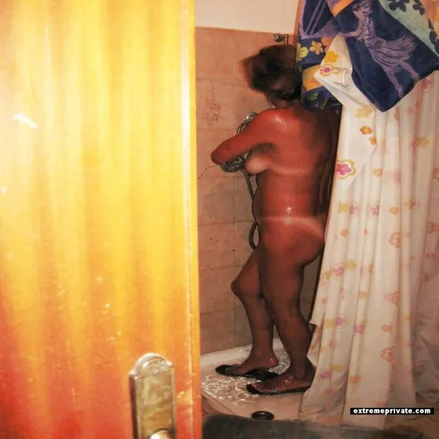 showering mother with sexy tan lines