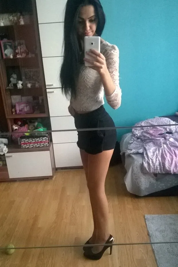 leggy brunette in black shorts and shiny platform heels