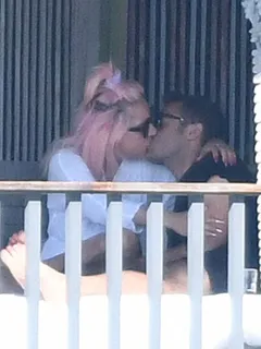 lady gaga caught kissing some new guy by paparazzi showing nice cleavage with her braless boobs in a robe and thong.