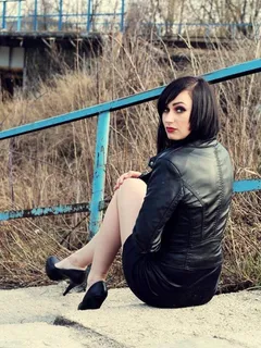 goth babe outdoors, leather jacket, short skirt and sexy long legs.