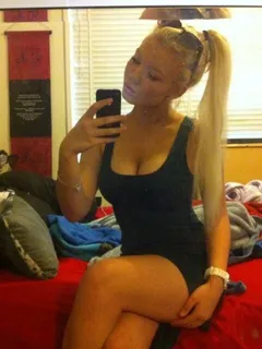 cute blonde in black minidress selfshot