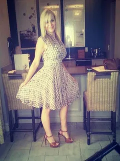 sexy mature blonde posing in nice dress and brown high heeled sandals